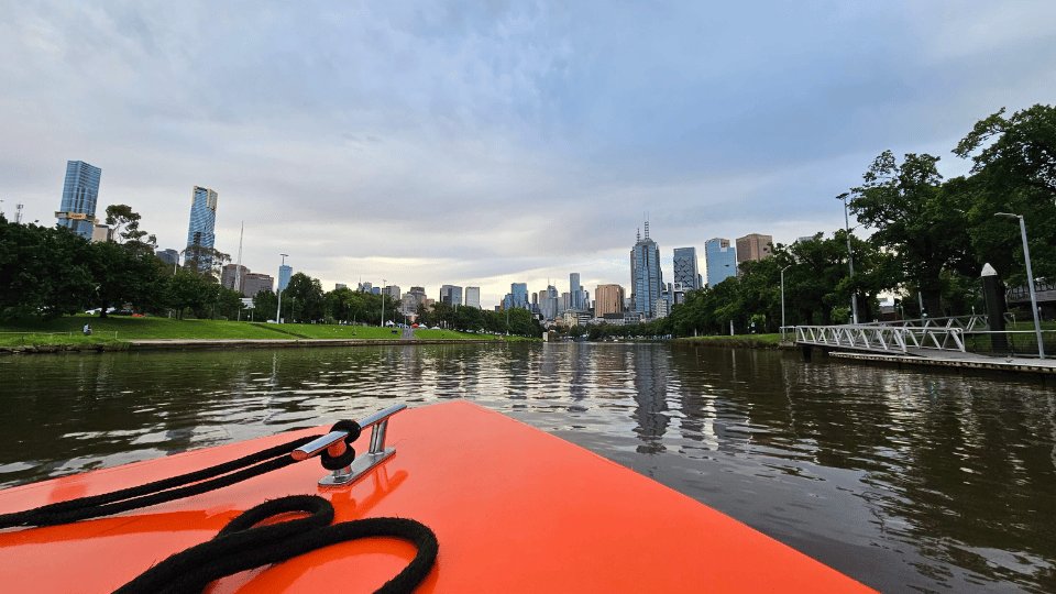 Melbourne copywriter cruising down the Yarra River with view of city in background.